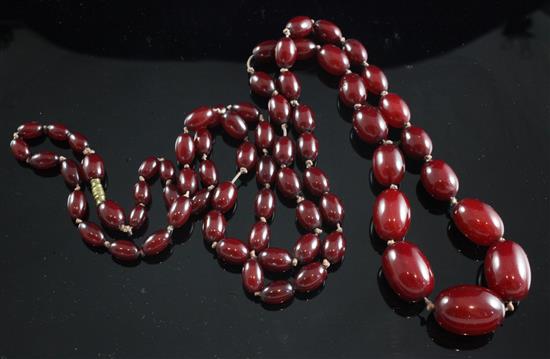 A single strand graduated cherry amberoid necklace, 46in.